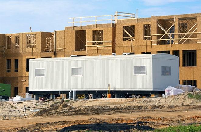 crane lifting modular building for construction office rentals in Alva